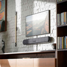 Bluesound Pulse Cinema Mini Multi-Room Streaming Soundbar Black lifestyle photo of unit wall mounted below TV