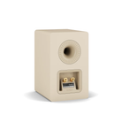 A single cream-colored Dali Kupid bookshelf speaker shown from the rear, featuring a circular waveguide and a terminal block with gold-plated connectors, set against a plain white background.
