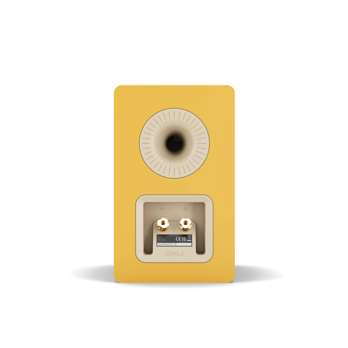 The rear view of a yellow DALI KUPID speaker on a white background, showing the back porting grille and terminal connectors.