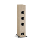 A tall, narrow floor-standing speaker with a light oak wood-grain finish and three black driver cones, shown on a plain white background.