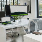 Modern office desk setup with dual monitors, laptop, and chair.