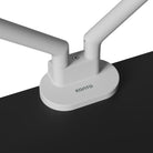 White double-armed desk lamp on a black surface with 'Kanto' branding.