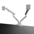 White dual monitor stand on a gray surface with a white background