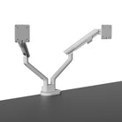 White dual monitor stand on a gray surface with a white background