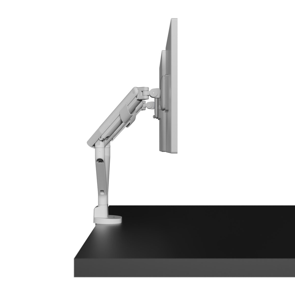 Monitor arm attached to a black desk on a white background