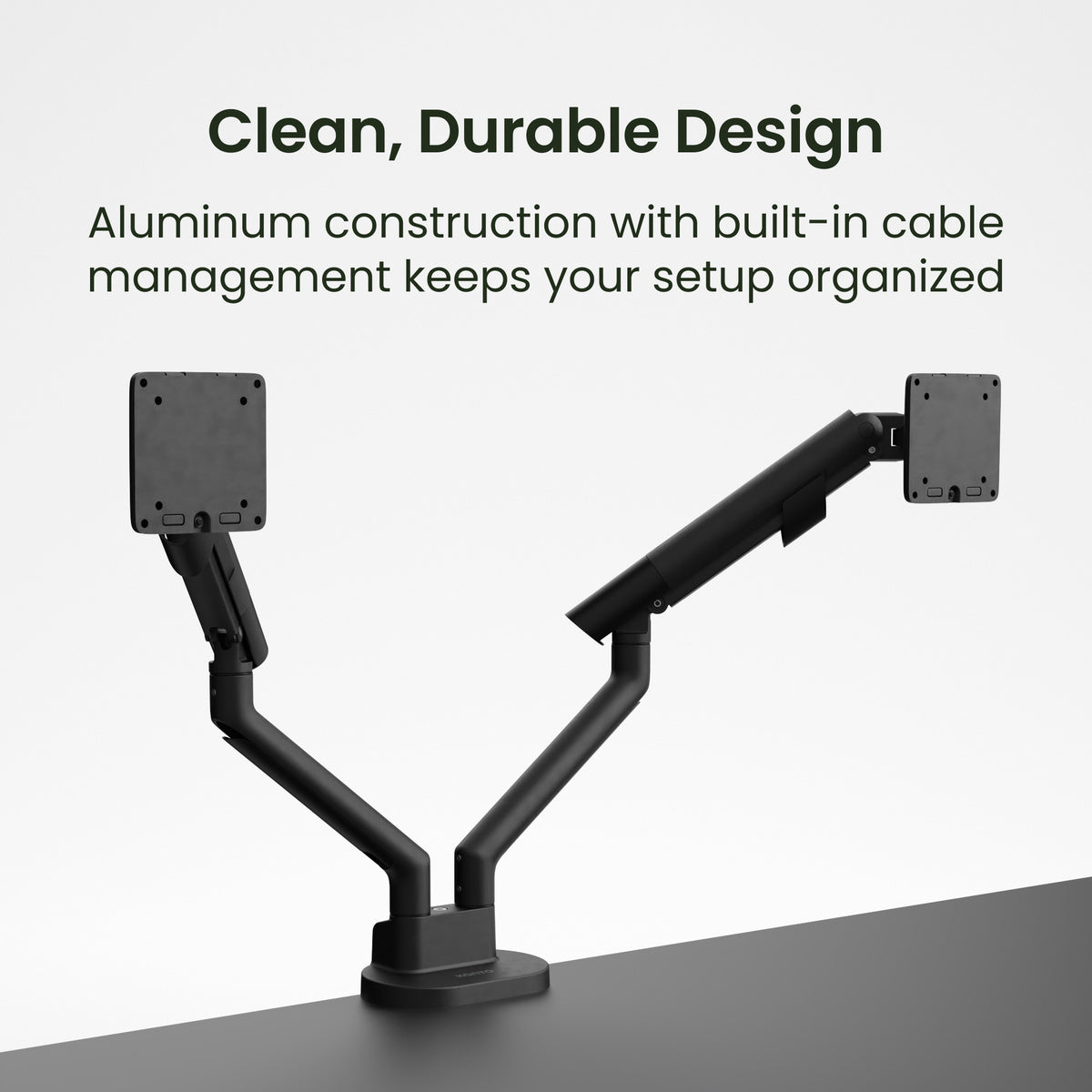 Black dual monitor stand with built-in cable management on a gray surface, text 'Clean, Durable Design' and 'Aluminum construction with built-in cable management keeps your setup organized'.