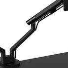 Black adjustable desk lamp on a white background