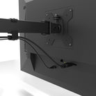 Monitor with a stand and attached cable on a white background
