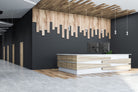 Modern interior design with a reception desk and wooden wall art.