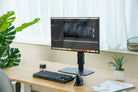 Modern office desk setup with a computer monitor, keyboard, and mouse.