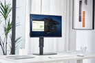 Monitor on a stand in a modern office setting with plants and decor.