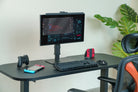 Gaming setup with monitor, keyboard, mouse, and gaming chairs on a desk.
