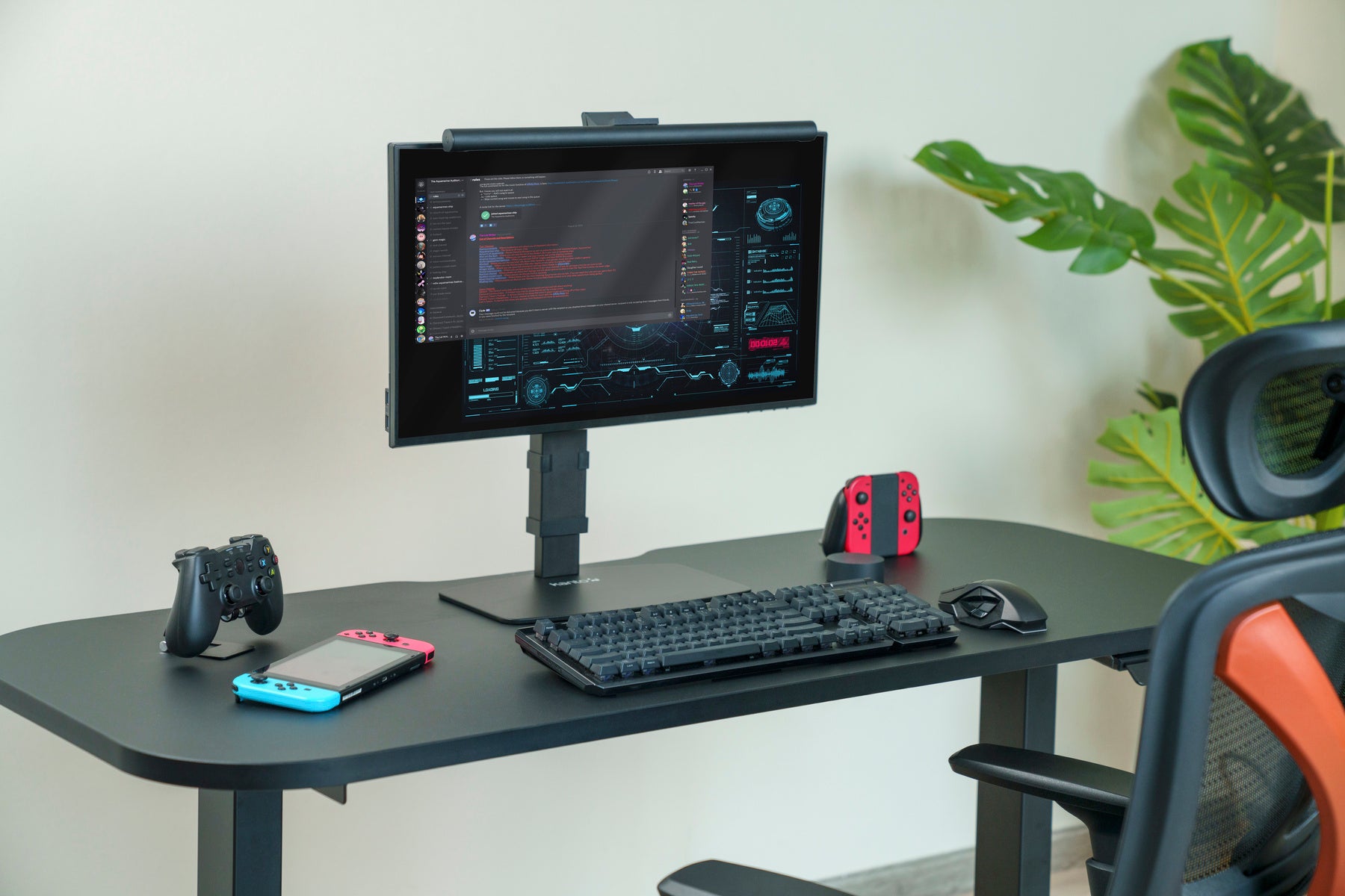Gaming setup with monitor, keyboard, mouse, and gaming chairs on a desk.