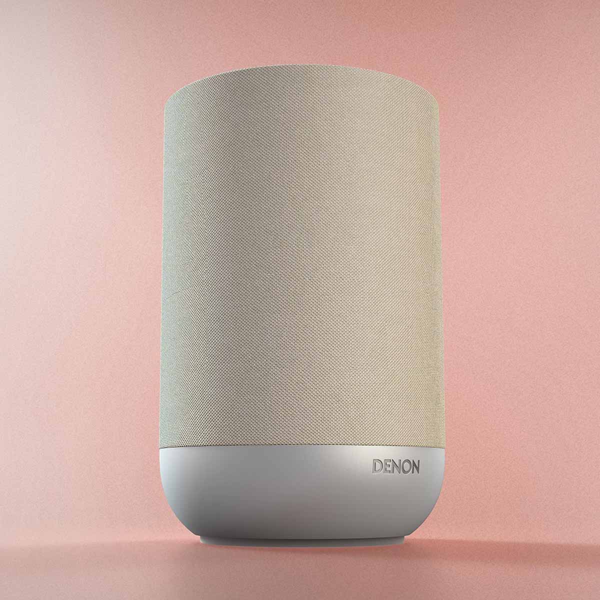 Denon Home 200 Stereo Wireless Smart Speaker - Silver - low angle side view angled right on pink background