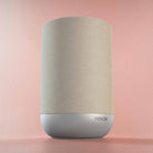Denon Home 200 Stereo Wireless Smart Speaker - Silver - low angle side view angled right on pink background