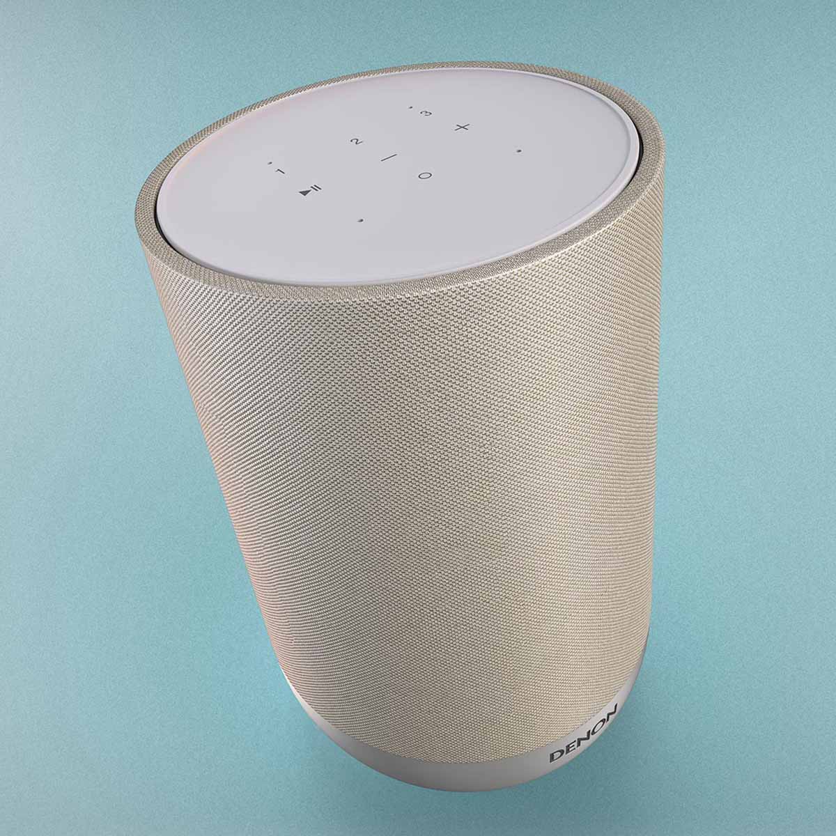 Denon Home 200 Stereo Wireless Smart Speaker - Silver - high angle top and side view angled right on light blue background