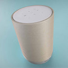 Denon Home 200 Stereo Wireless Smart Speaker - Silver - high angle top and side view angled right on light blue background