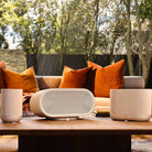 Denon Home Stereo Wireless Smart Speakers - Silver - lifestyle photo front view of each unit in series, from left to right the 200, 600 and 400 with couch and backyard in background