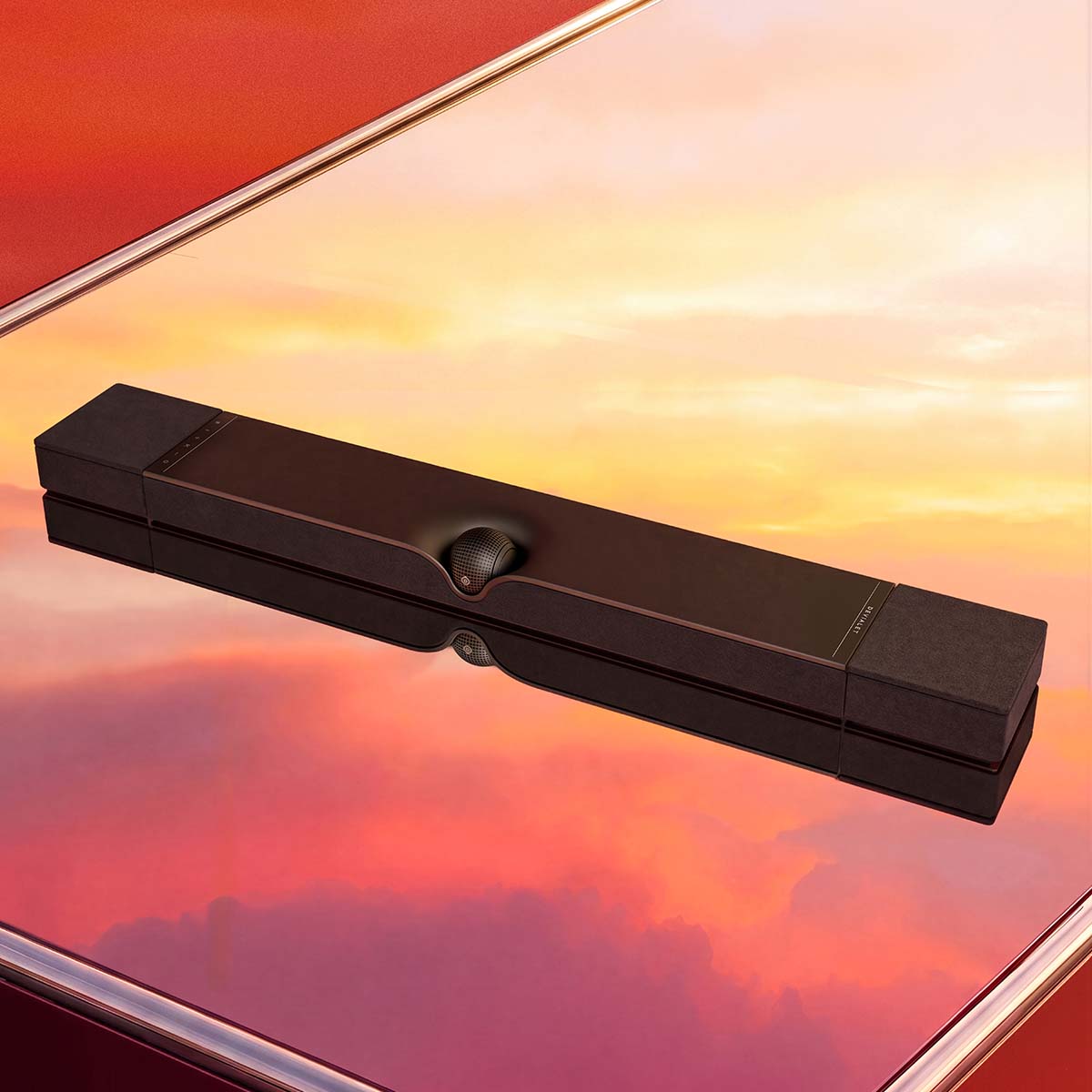 Devialet Dione Dolby Atmos Soundbar - lifestyle photo of soundbar on mirrored cabinet at sunset