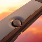 Devialet Dione Dolby Atmos Soundbar - lifestyle photo closeup of soundbar on mirrored cabinet at sunset