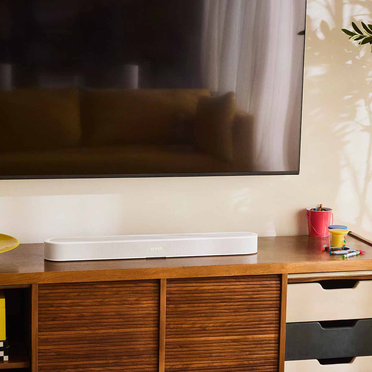 Sonos Beam Ultra Soundbar - lifestyle photo of white soundbar on a cabinet in a living room