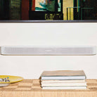 Sonos Beam Ultra Soundbar - lifestyle photo of black soundbar mounted on a wall below a TV