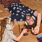 Sonos Ace Ultra Wireless Over-Ear Headphones - lifestyle photo of a man and child both wearing white headphones playing with toys