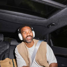Sonos Ace Ultra Wireless Over-Ear Headphones - lifestyle photo of a man in a car wearing white headphones