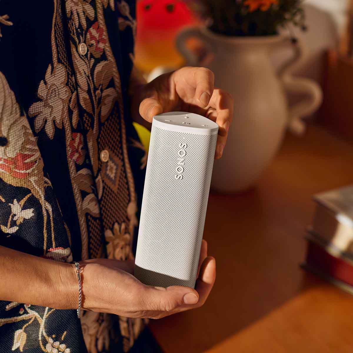 Sonos Roam 2 Portable Waterproof Smart Speaker - white - lifestyle photo person holding speaker