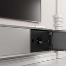 Lyngdorf CS-2 Speaker lifestyle shot front view angled of single unit in cabinet below TV