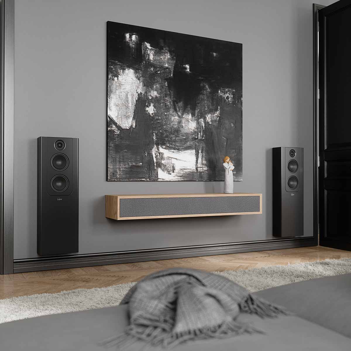 Lyngdorf FR-2 Speaker - lifestyle shot of black speakers with black baffles mounted on wall