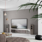 Lyngdorf FR-2 Speaker - lifestyle shot of mocca speakers with mocca baffles on floor next to wall