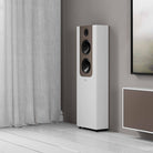 Lyngdorf FR-2 Speaker - lifestyle shot of single white speaker with mocca baffle on floor