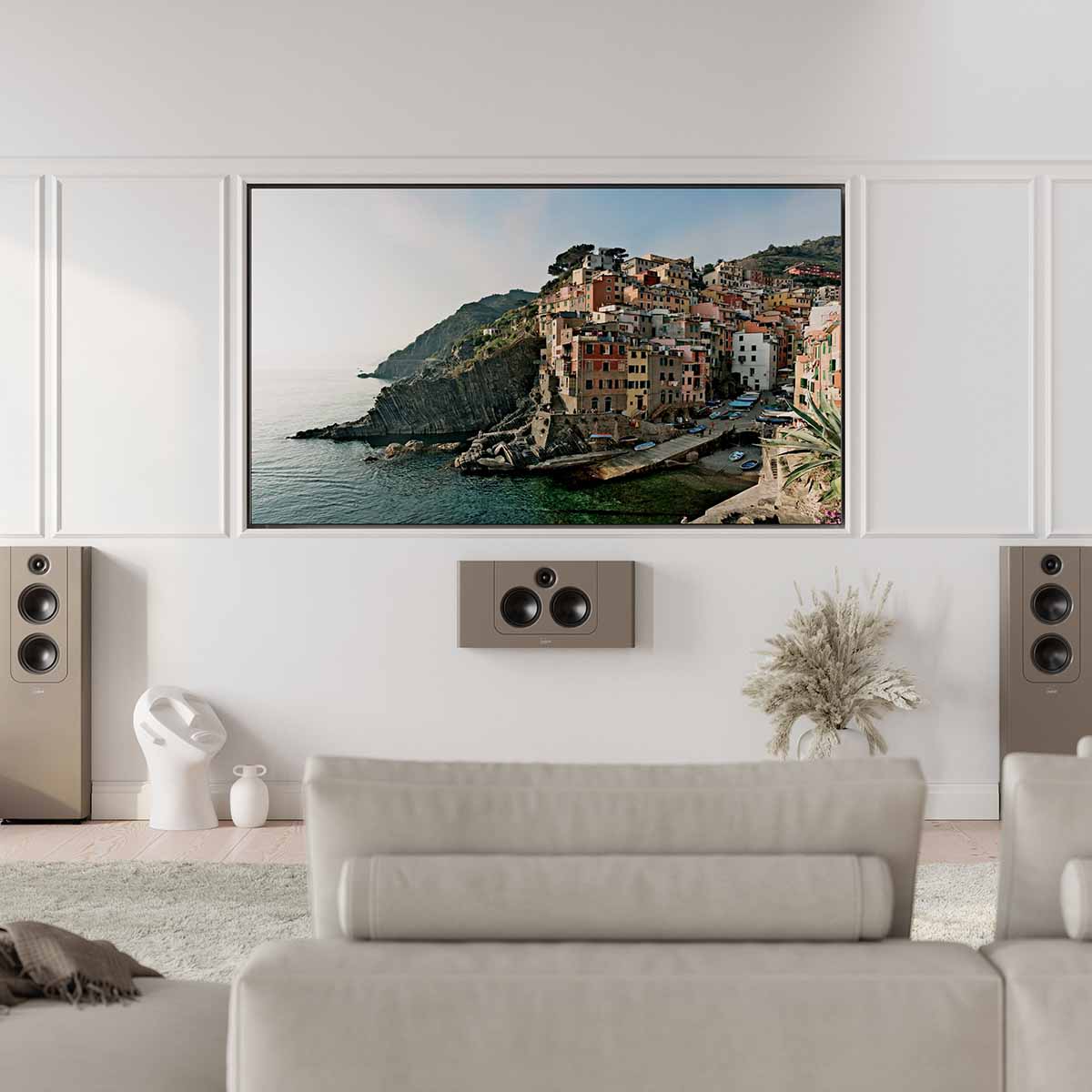 Lyngdorf LCR-2 On-Wall LCR Speaker - lifestyle photo brown speaker mounted below TV with brown Lyngdorf FR-2's to either side