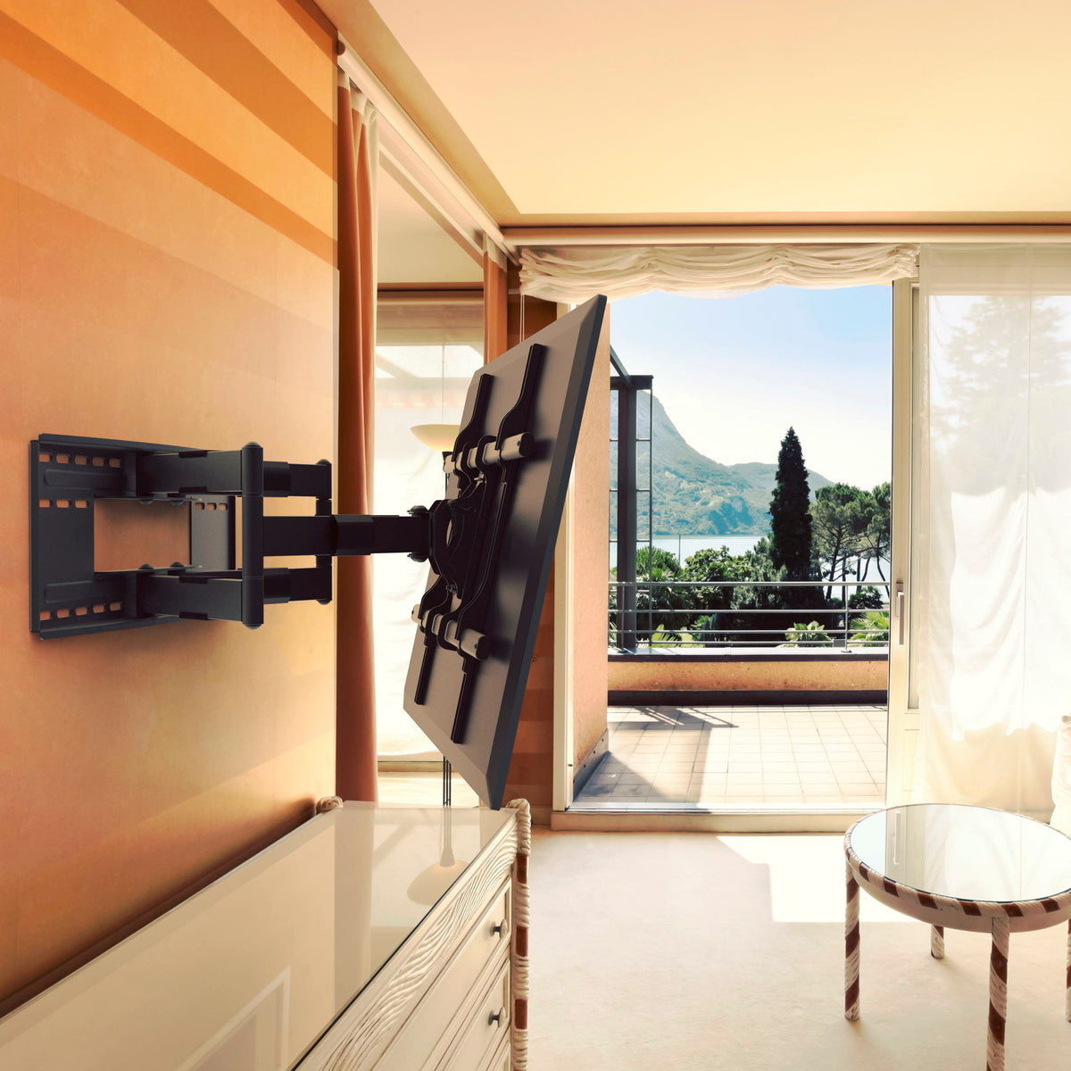 TV mounted on a wall in a room with a view of mountains and trees