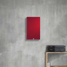 Lyngdorf FR-1 Speaker lifestyle shot front view white unit with red grille mounted on gray wall