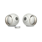 Devialet Phantom Ultimate 98 dB High-End Connected Speaker - Light Pearl - pair of speakers facing inward with remote center left