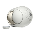 Devialet Phantom Ultimate 108 dB High-End Connected Speaker - Light Pearl - facing right with remote to left