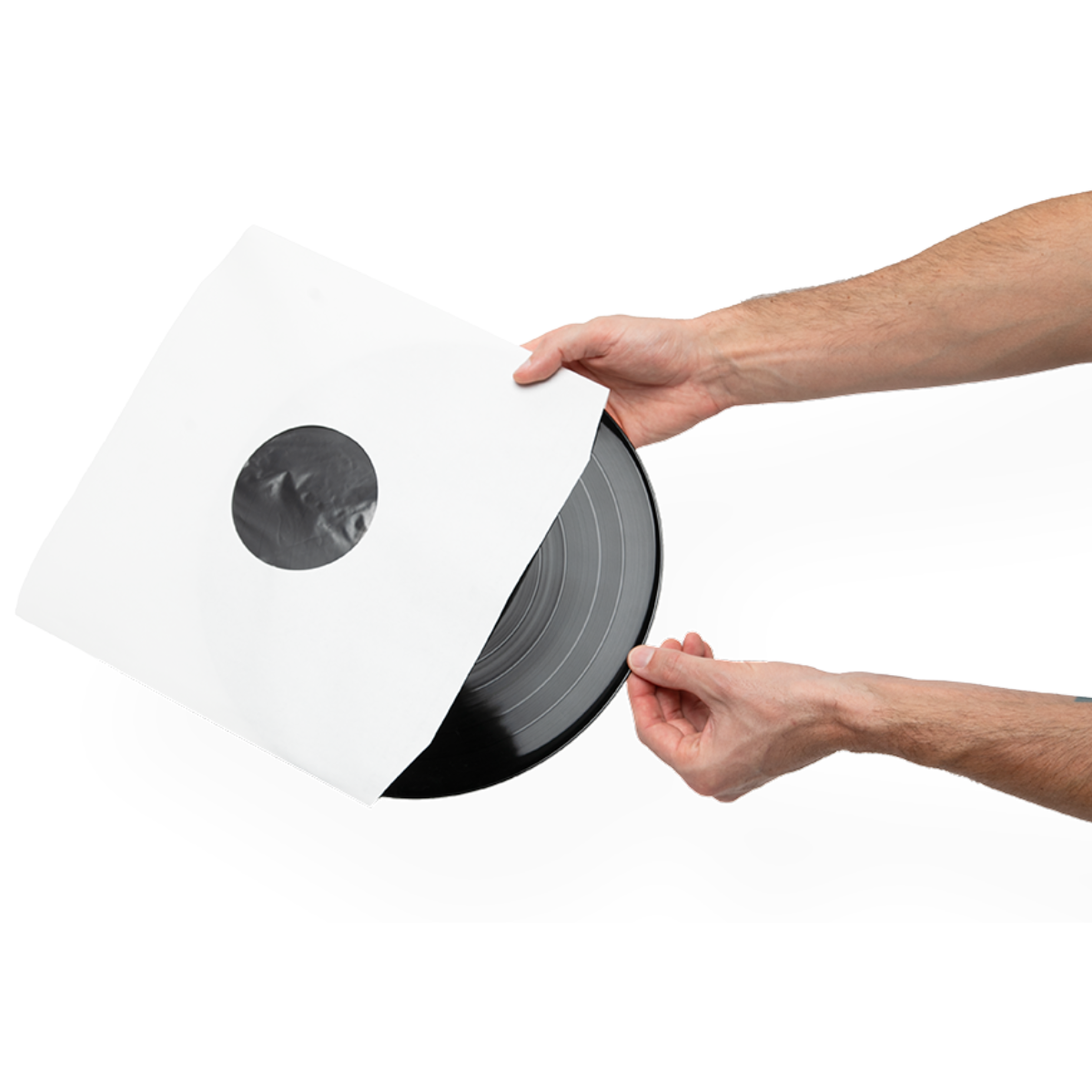 A person's hands holding a black vinyl record partially pulled from its white paper sleeve against a solid white background.