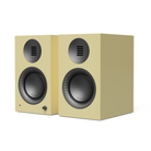 A pair of gloss yellow Kanto TUK Gen 2 260W Premium Powered Speaker System with black drivers and a small silver control knob, shown on a clean white background.