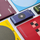Several Kanto brand product boxes and packaging pieces arranged on a white surface, including a blue box labeled 'Turntable Setup and Alignment Kit' and other colorful boxes in maroon, yellow, green, and red.