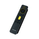 A black Arcam remote control with yellow accent buttons and a yellow directional ring, shown on a plain white background.