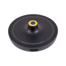 A black circular Arcam calibration microphone with a yellow accent ring around the center pin, featuring a USB-C port on the side and white text that reads 'precision tuning microphone' on a clean white background.