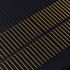 Close-up of a Arcam Radia AVA15 9-channel Class D Home Theater Receiver with repeating diagonal gold metallic contacts.