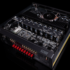 An internal view of a black Arcam Radia AVA25 9-channel Class A/B Home Theater Receiver showing the complex circuitry, heat sinks, and red terminal connectors on a black background.