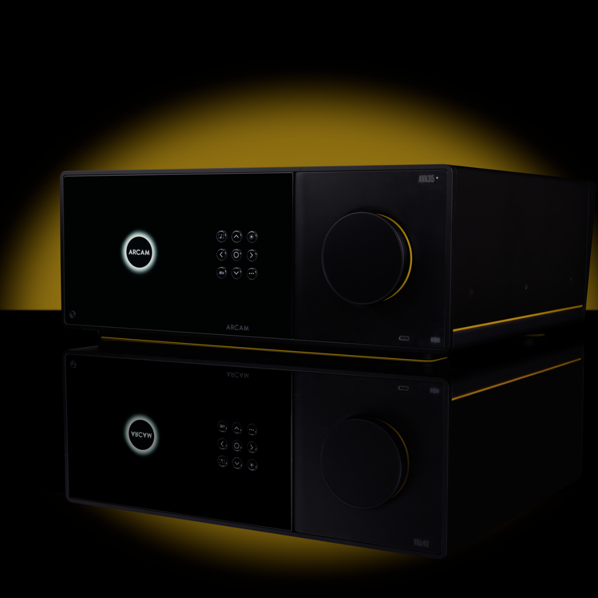 Black Arcam Radia AVA35 9-channel Class G Home Theater Receiver with digital display and buttons on a reflective surface with a yellow glow.