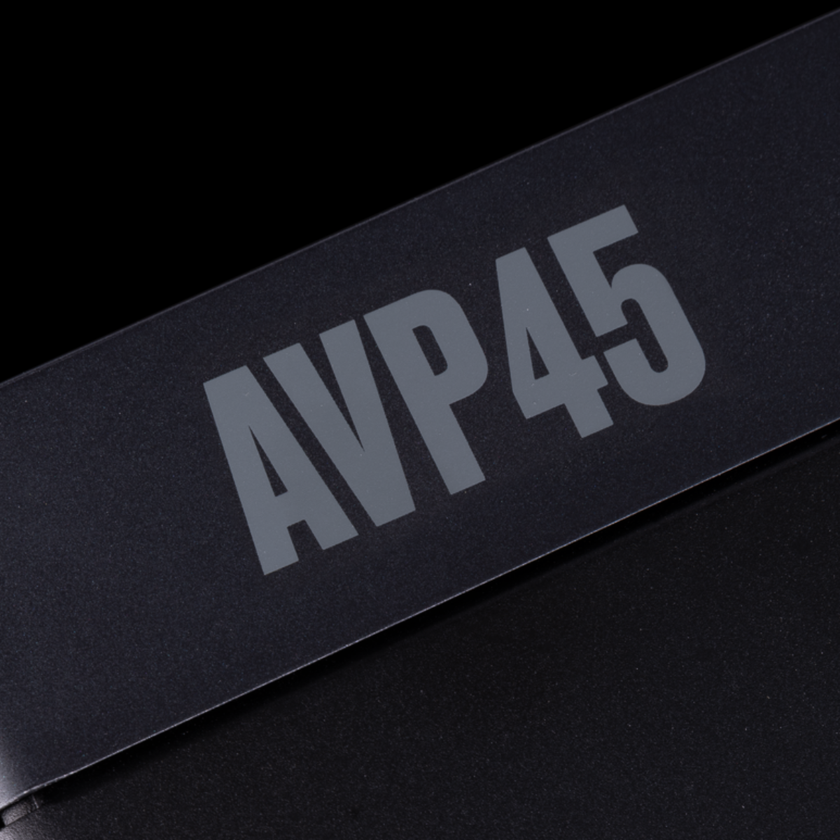 Close-up of a black rectangular product with large gray 'AVP45' lettering on a black background.