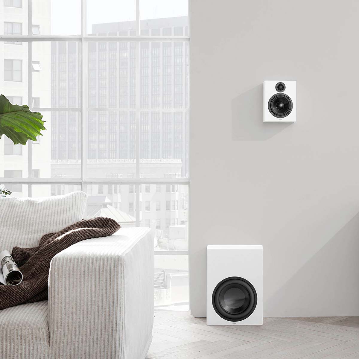 Lyngdorf MH-2 Satellite Speaker white speaker lifestyle shot mounted on wall without grille