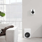 Lyngdorf MH-2 Satellite Speaker white speaker lifestyle shot mounted on wall without grille