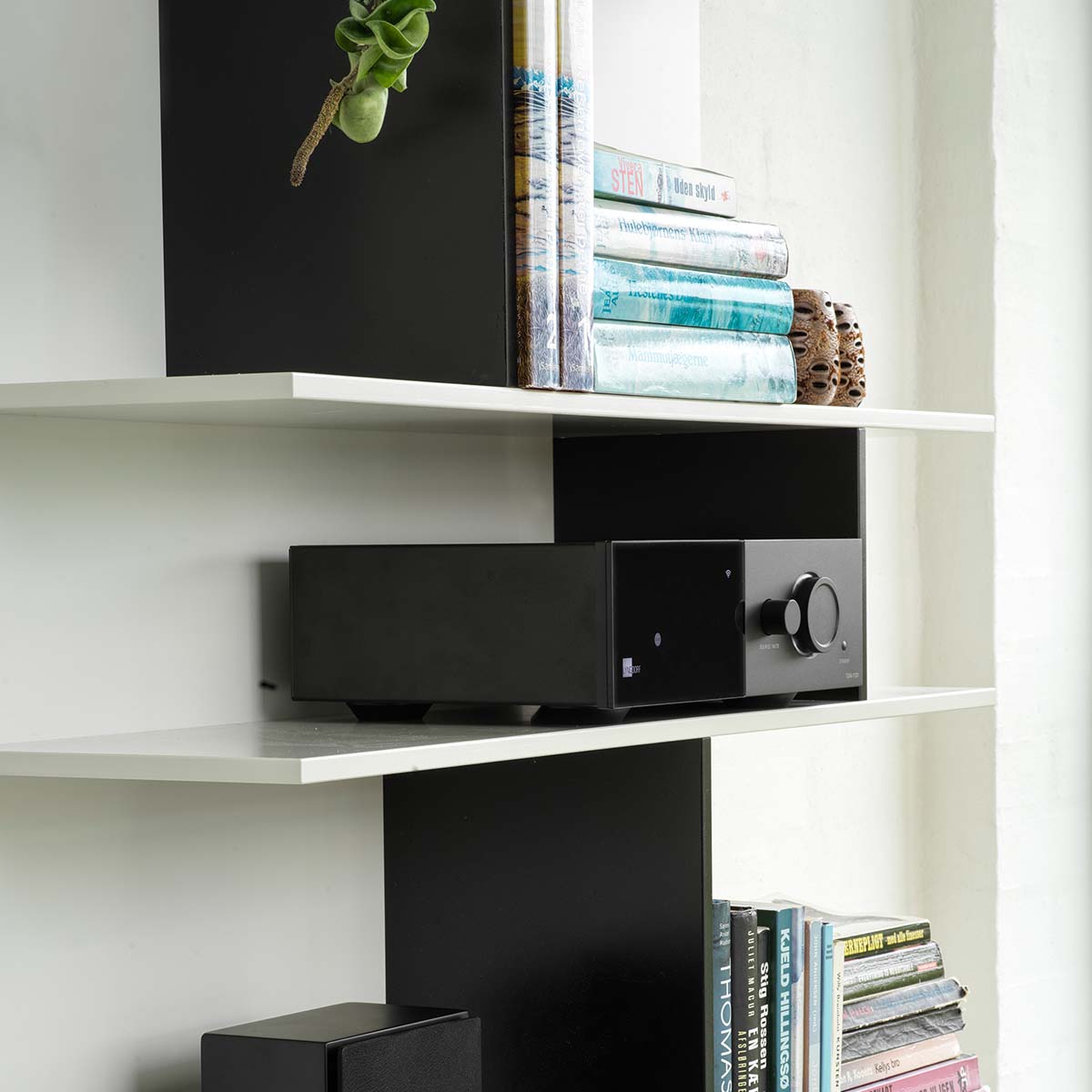 Lyngdorf TDAI-1120 Compact Streaming Amplifier with RoomPerfect lifestyle shot of unit on shelf